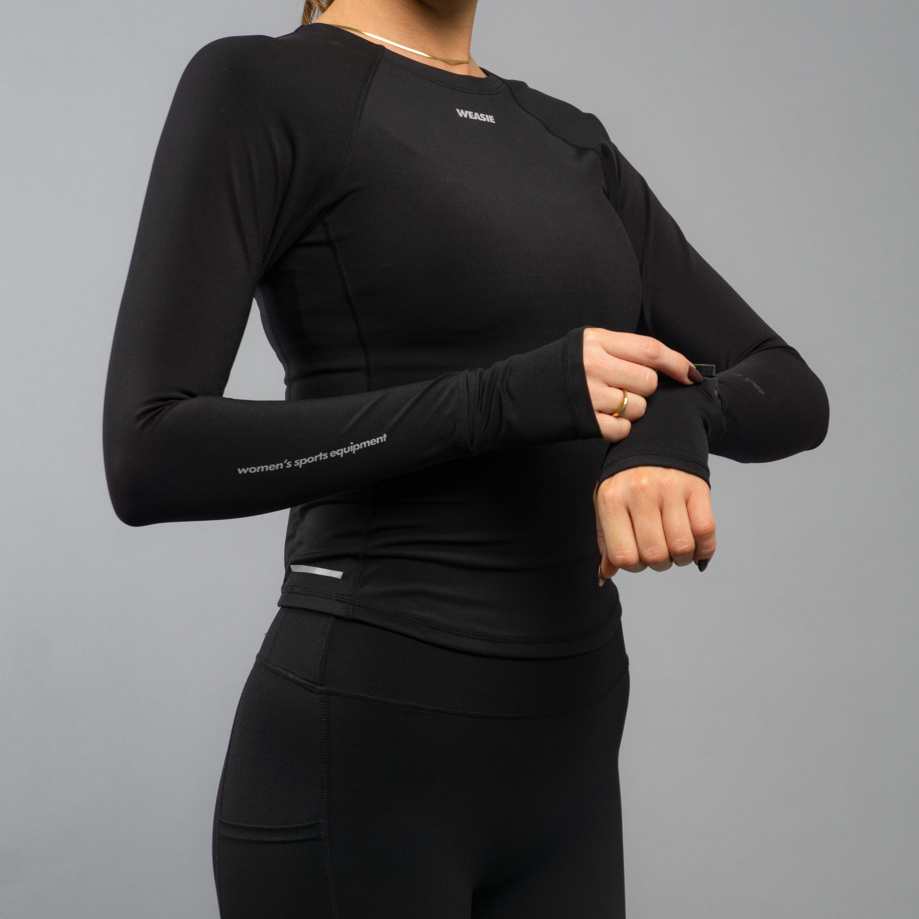 Side view of black long sleeve training top with watch hole and thumbhole cuffs – WEASIE