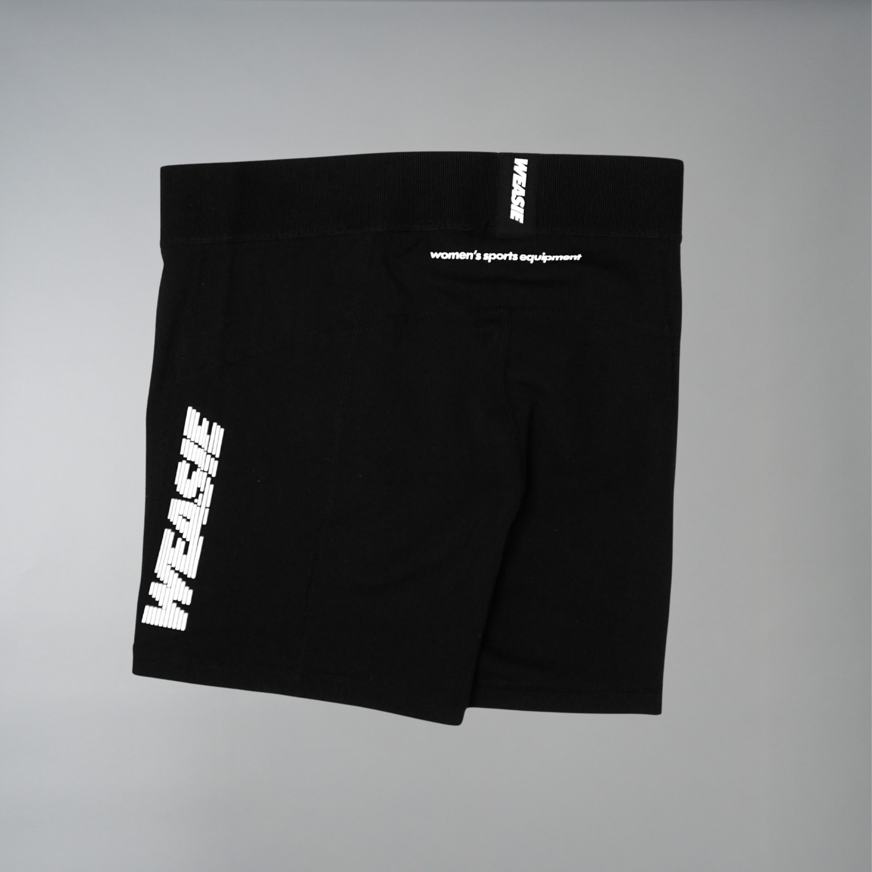 Women's black speed running shorts with WEASIE reflective logo, flat lay – WEASIE